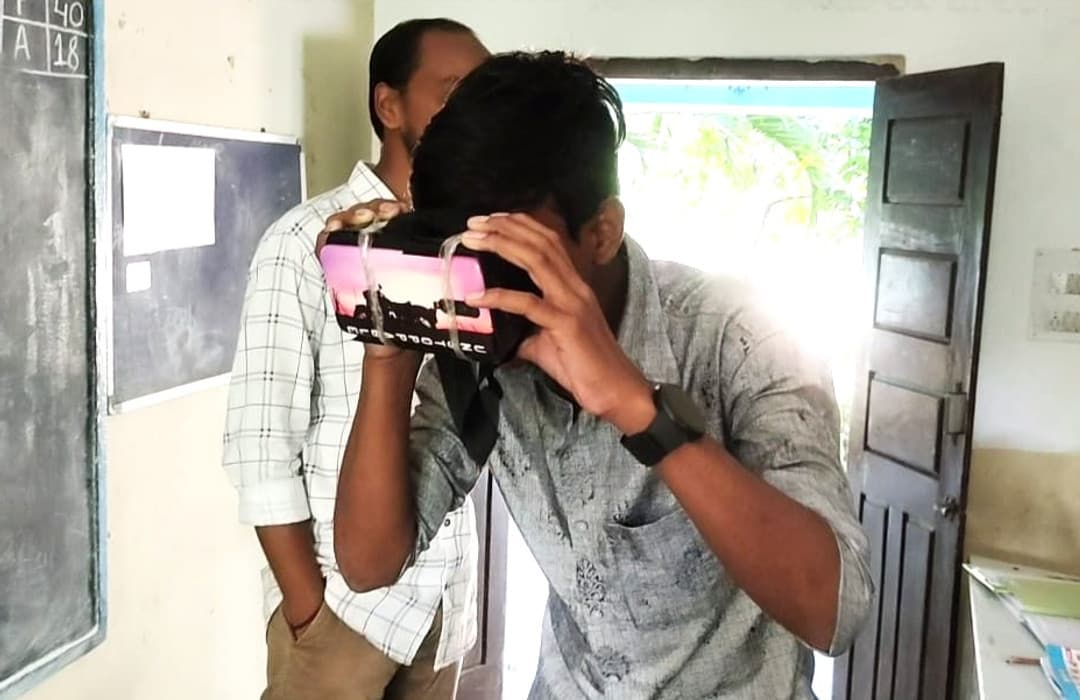 A student trying an AR viewer with a phone during a school demo